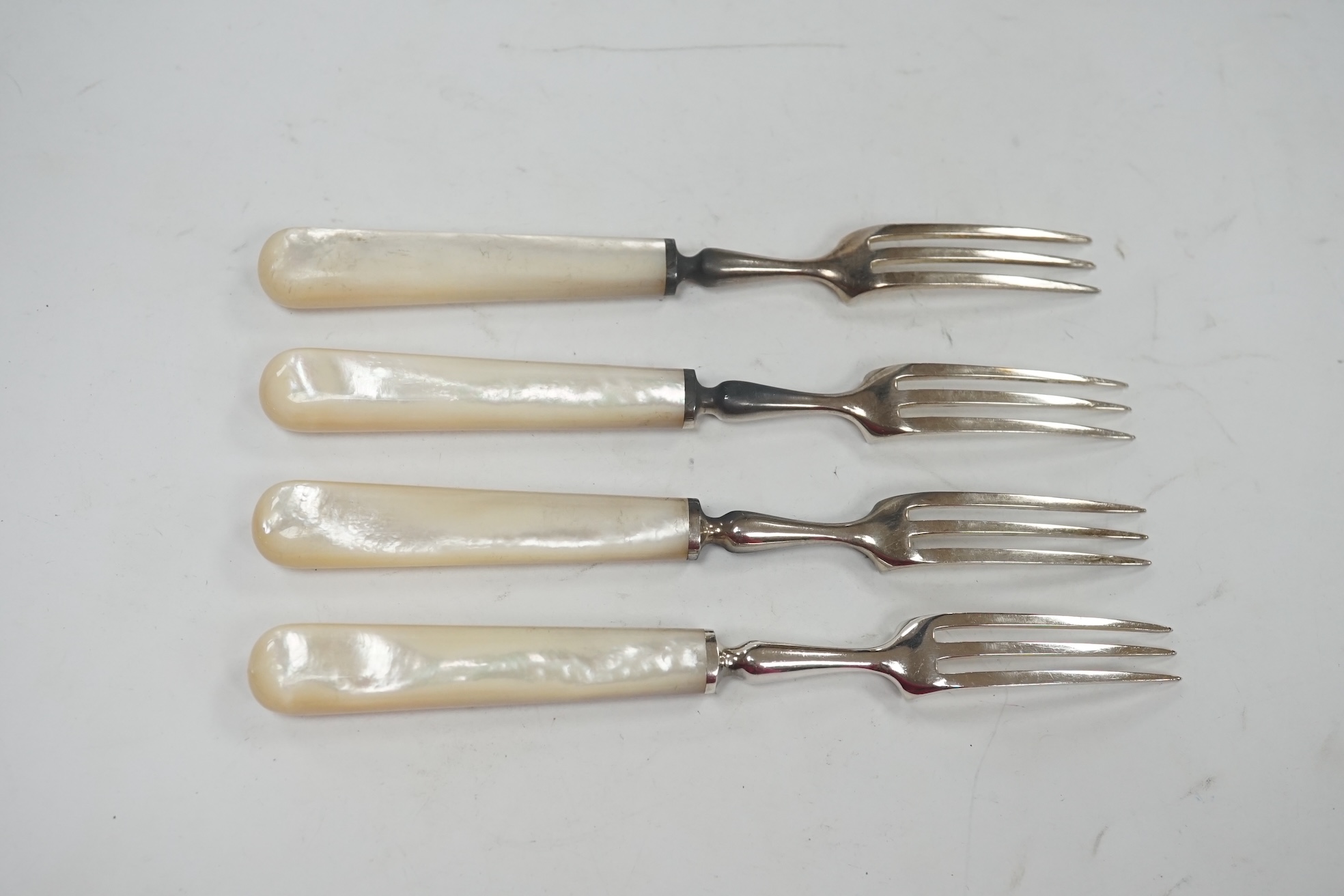 Twelve pairs of George V mother of pearl handled silver fruit knives by Atkin Brothers, Sheffield, 1933, knife 19.1cm. Condition - fair to good